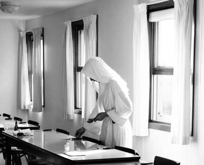 A nun of Valley of Our Lady prepares the refectory.