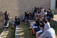 Fr. Ambrose and his New Testament class go outside to discuss Jesus' preaching through the use of parables.