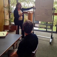 Mme. Obels-Robinson, our new French teacher, is shown giving some private tutoring to a senior that wanted to improve his French.