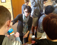 Sophomores studying freezing-point depression work with Mrs. Lourdes Baker to make ice cream. 